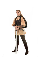 full length portrait of girl wearing brown medieval costume,. standing pose, isolated on white studio background.
