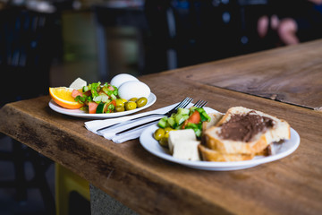 Two plates at a rustic breakfast bar