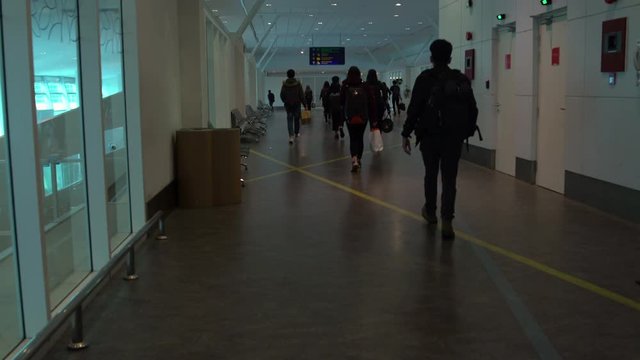 Passengers go along the corridor of the airport