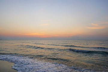 Morning on sea, Beautiful nature blue sky with clouds. Colorful sky as a background. Soft wave of the sea on the sandy beach at  Cha-am beach, Thailand. Space for text in template. Travel concept.