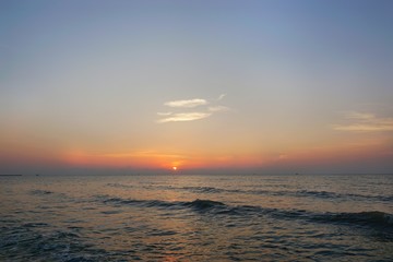 Obraz premium Morning on sea, Beautiful nature blue sky with clouds. Colorful sky as a background. Soft wave of the sea on the sandy beach at Cha-am beach, Thailand. Space for text in template. Travel concept.