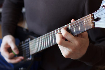 Obraz na płótnie Canvas Man is playing guitar close up