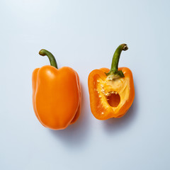 halves of yellow sweet pepper on a gray background
