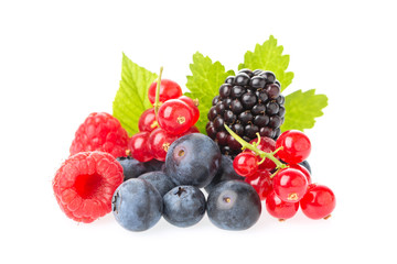 Healthy fresh food berries group. Macro shot of fresh raspberries, blueberries, blackberries, red currant and blackberry with leaves isolated on white background.