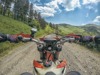 Extreme Adventure traveller with the dirt bike Enduro in high Caucasus mountains