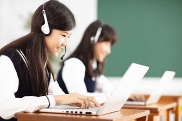 teenager student learning online with headphones and laptop