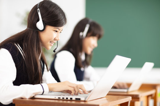 Teenager Student Learning Online With Headphones And Laptop