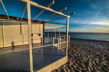 Fototapeta na wymiar Wooden terrace by the sea in Sardinia