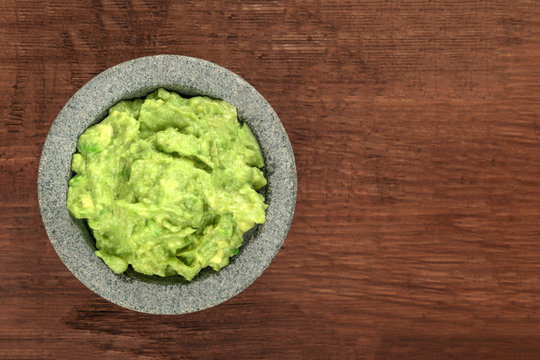 A photo of guacamole sauce in a molcajete, traditional Mexican mortar