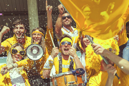 group of fans dressed in yellow color