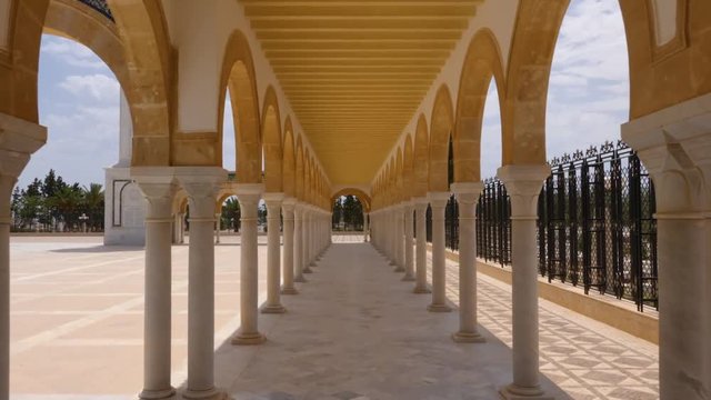 Traveler standing at columns in Bourguiba mausoleum in Monastir, Tunisia