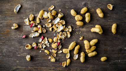 Healthy and diet food. Unpeeled peanuts on wooden rustic backgro