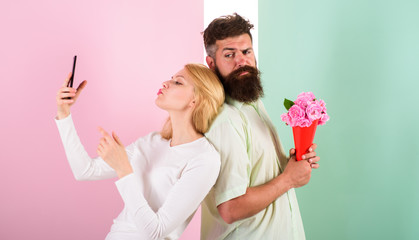 Sharing happy selfie. Woman capturing happy moment boyfriend bring bouquet flowers. Couple in love...