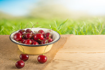 Sweet cherries in a plate in the nature