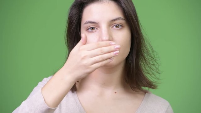Young beautiful woman covering mouth as three wise monkeys concept