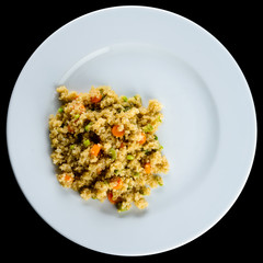 Delicious pilaf with vegetables and herbs in a white plate isola