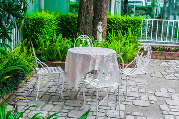 English Garden Table Set with White Steel Chair In the outdoor garden For relaxation.