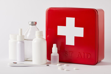 close-up shot of first aid kit box with different medical supplies on white