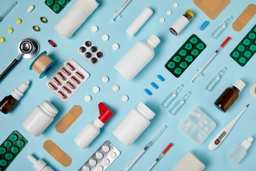 full frame shot of composed different medical supplies on blue surface