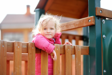 Cute little girl having fun on outdoor playground