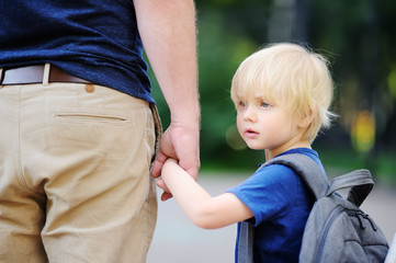 Fototapeta na wymiar Back to school concept. Little pupil with his father. First day of primary school.