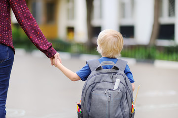Little pupil with his young mother. First day of primary school.