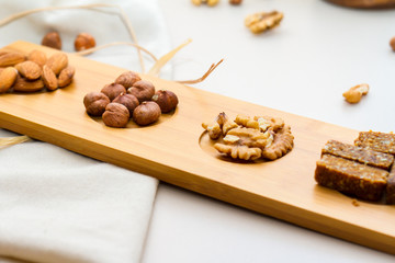 Nuts and Date Palm in Wooden Plate