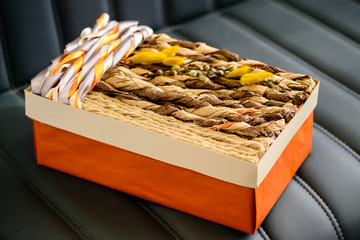 Holiday decor concept. Handmade gift box wrapped with simple bro
