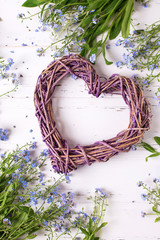 Decorative   heart and frame  from  blue forget-me-nots or myosotis flowers