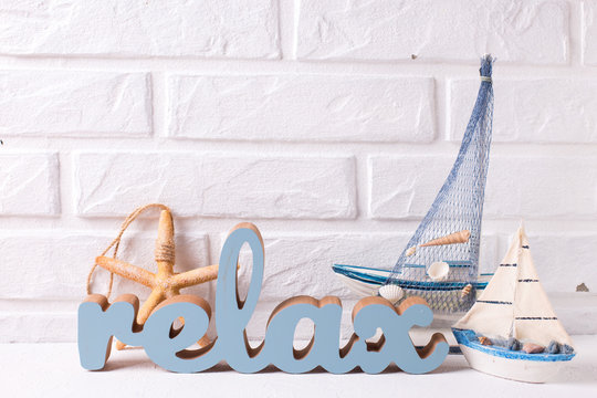 Word relax and marine  decorations on white textured  background.