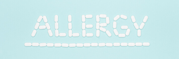 Allergy. Allergens, antihistamin pills, seasonal allergies. Minimal flat lay grass pollen allergy concept.