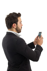 bearded person wears black jacket and white shirt. Isolated. Man on his back is typing on his cell phone..