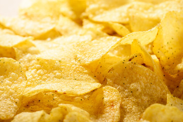 Food background of delicious chips. Corrugated golden chips pota