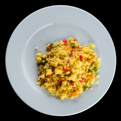 Delicious pilaf with vegetables and herbs in a white plate isola