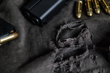 9mm semi autometic hand gun with FMJ bullet on fabric