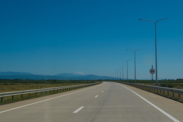 Fototapeta premium Road trip view from the car asphalt and blue sky
