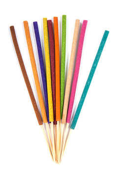 Vertical colorful incense sticks isolated on white background