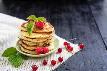 Sweet pancekes with strawberry on black background. Copy space