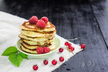 Sweet pancekes with strawberry on black background. Copy space