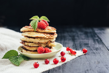 Sweet pancekes with strawberry on black background. Copy space