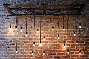 Old red brick wall with bulb lights lamp