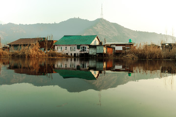 Mirror of village and mountain in lake
