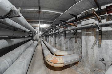 Leaving the wall of the heating duct pipe in underground concrete utility tunnel network of water...