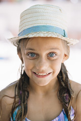 Little girl with a hat outdoors