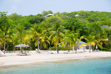 Obraz premium Antigua, Caribbean islands. English Harbour view with Galeon beach, sun beds and umbrellas
