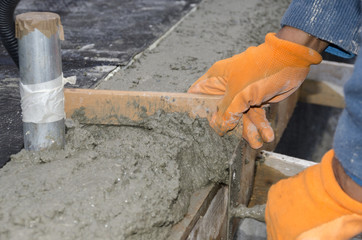 worker while splitting the concrete with the jackhammer during the renovation of a roof