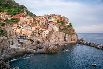Fototapeta na wymiar Manarola - Village of Cinque Terre National Park at Coast of Italy. Beautiful colors at sunset. Province of La Spezia, Liguria, in the north of Italy - Travel destination and attractions in Europe.