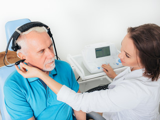 Senior man in hospital having ear test.