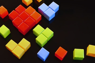 children's colored cubes in the form of a heart on a dark background