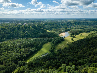 Fototapeta na wymiar drone image. aerial view of rural area with dramatic clouds over river of Gauja in Sigulda district. Latvia